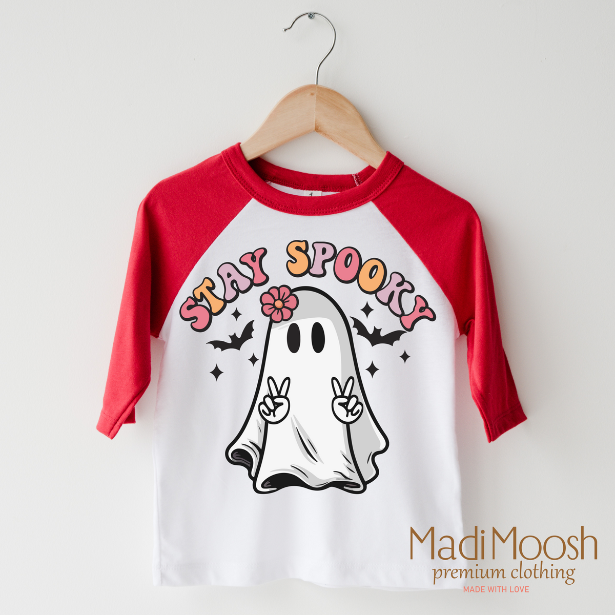 Stay Spooky design on a raglan shirt with red sleeves.