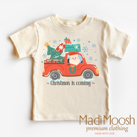 Christmas Is Coming graphic T-shirt by Madi Moosh