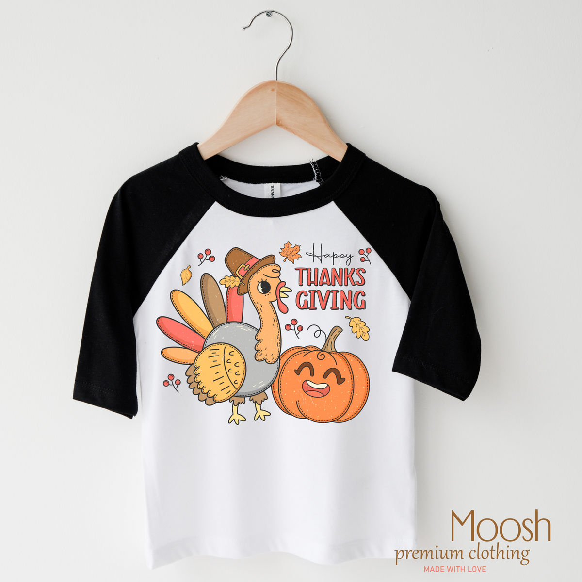 Happy Thanksgiving design on a raglan shirt with black sleeves.