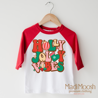 Holly Jolly Vibes design on a raglan shirt with red sleeves.