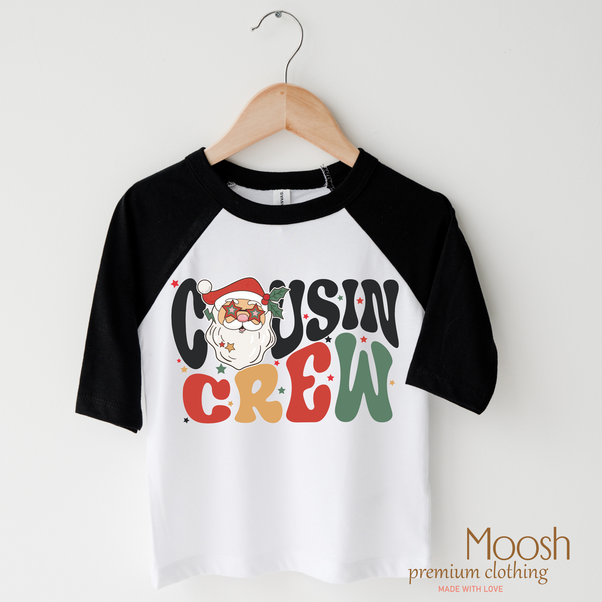 Christmas Cousin Crew design on a raglan shirt with black sleeves.
