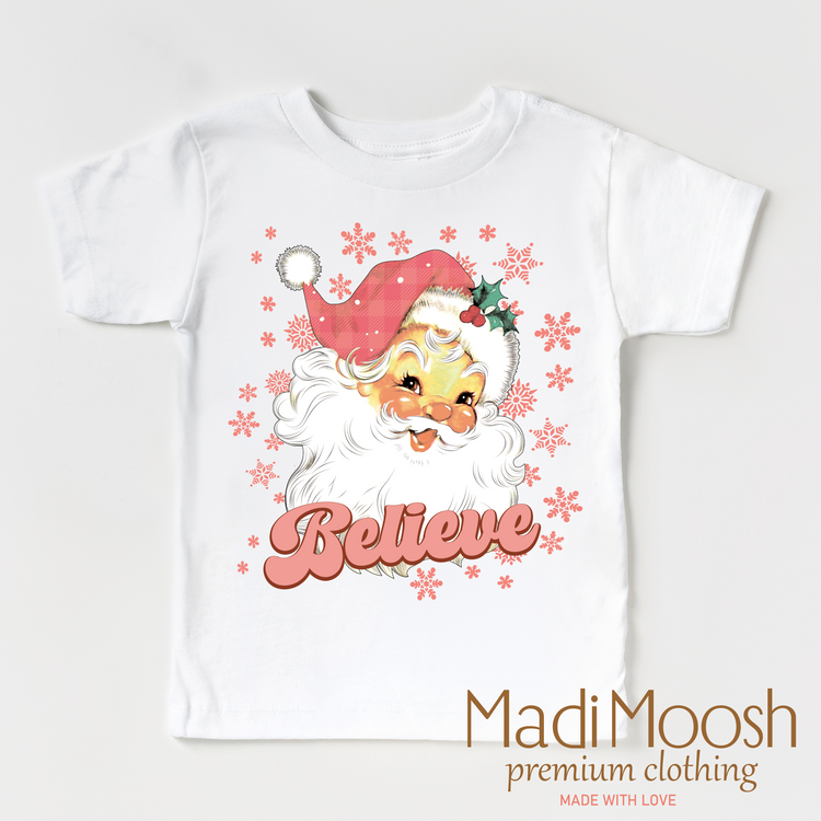 Santa Claus Believe, Christmas graphic T-shirt by Madi Moosh