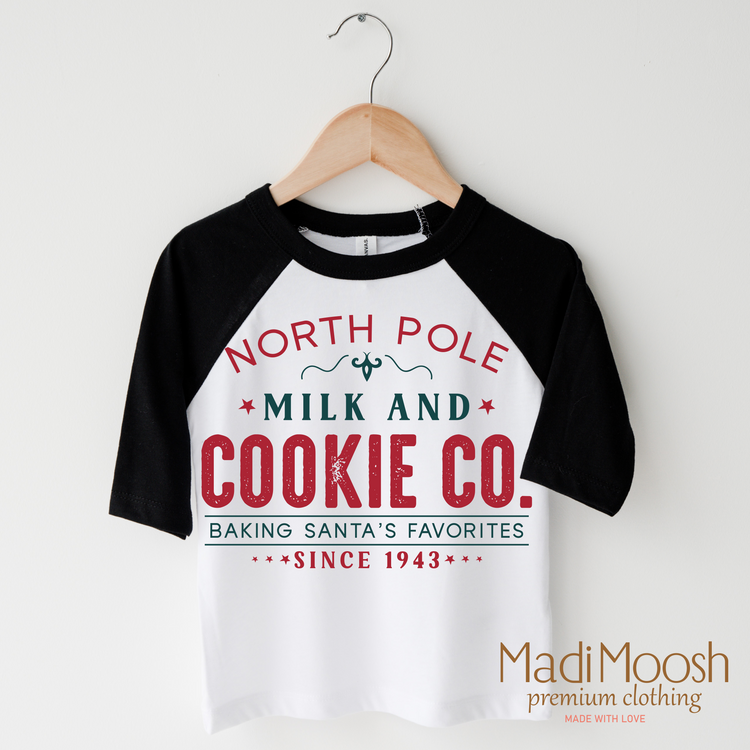 North Pole Milk And Cookie Company, Christmas graphic T-shirt by Madi Moosh