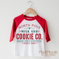 North Pole Milk and Cookie Company design on a red-accented shirt.