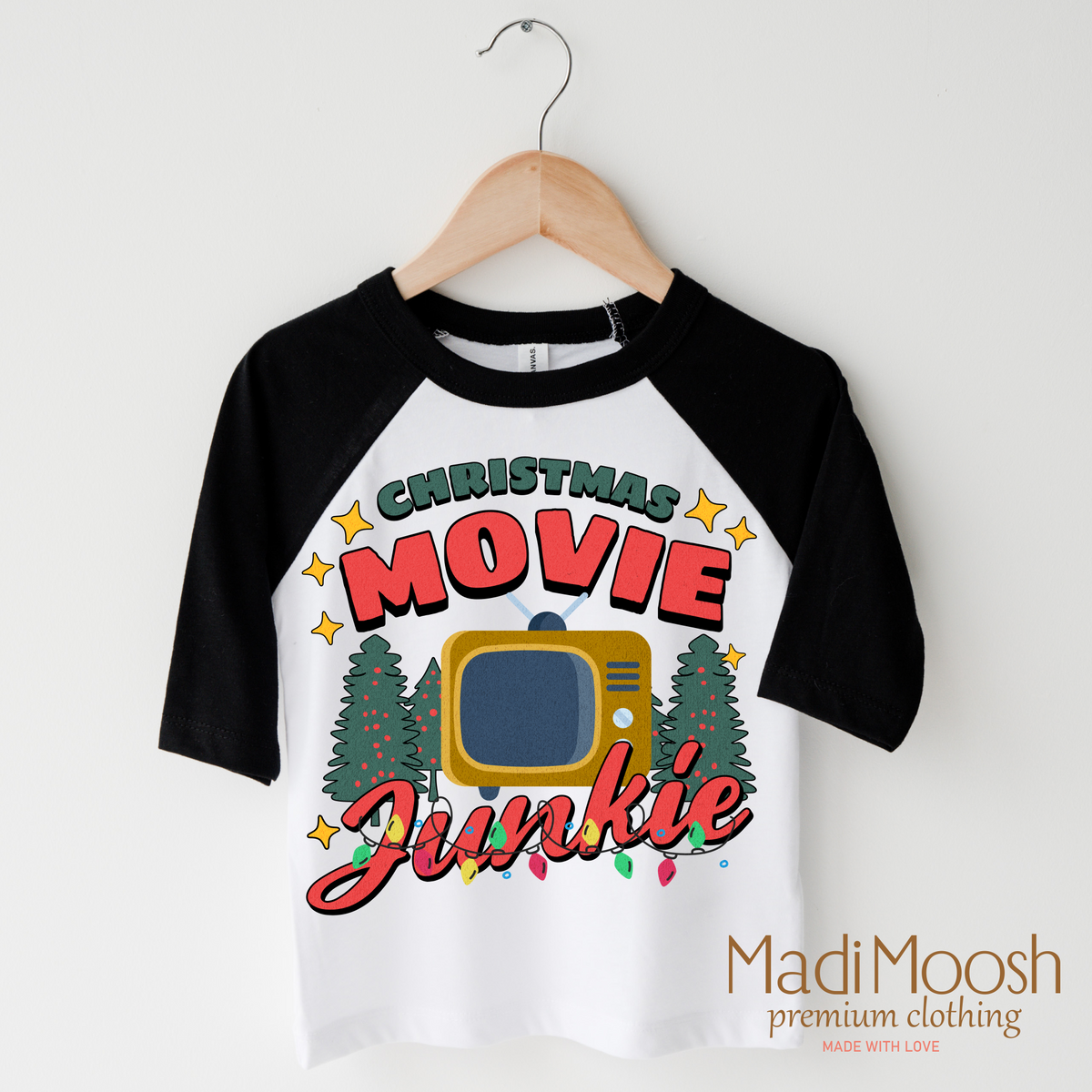 Christmas Movie Junkie design on a black-accented shirt.