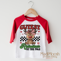 Cutest Reindeer at the Pole design on a red-accented shirt.