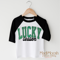 Lucky Season St. Patrick's Day design on a black-accented shirt.
