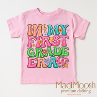 In My 1st Grade Era Back To School design on a pink garment.