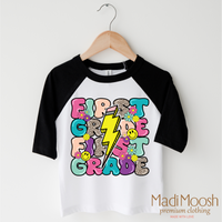 First Grade Lightning Bolt Back To School design on a black-accented shirt.