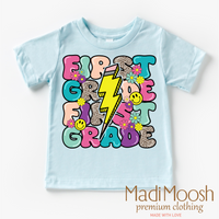 First Grade Lightning Bolt Back To School design on a blue garment.