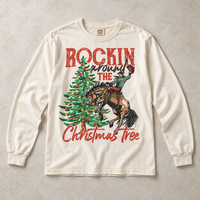Ivory Comfort Colors long-sleeve tee featuring Rockin Around the Christmas Tree cowboy and bucking horse graphic