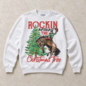 White Gildan sweatshirt featuring Rockin Around the Christmas Tree cowboy and bucking horse graphic