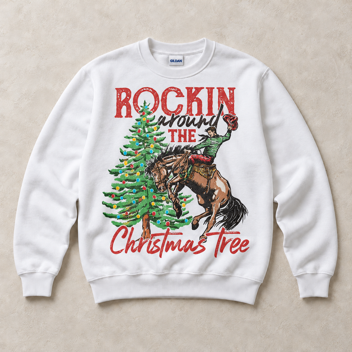 White Gildan sweatshirt featuring Rockin Around the Christmas Tree cowboy and bucking horse graphic