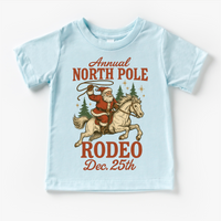 North Pole Rodeo Cowboy Christmas design on a blue garment.