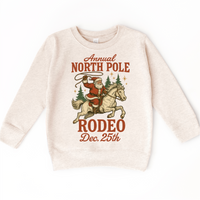 North Pole Rodeo Cowboy Christmas design on a natural sweatshirt.