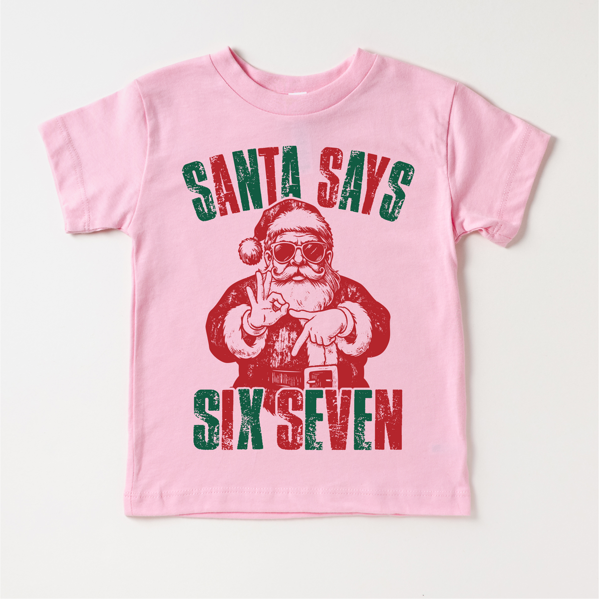 Santa Says Six Seven Christmas design on a pink garment.