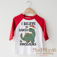 I Believe In Santa And Dinosaurs Christmas design on a raglan shirt with red sleeves.