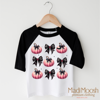 Cute Halloween Pumpkins And Bows design on a black-accented shirt.