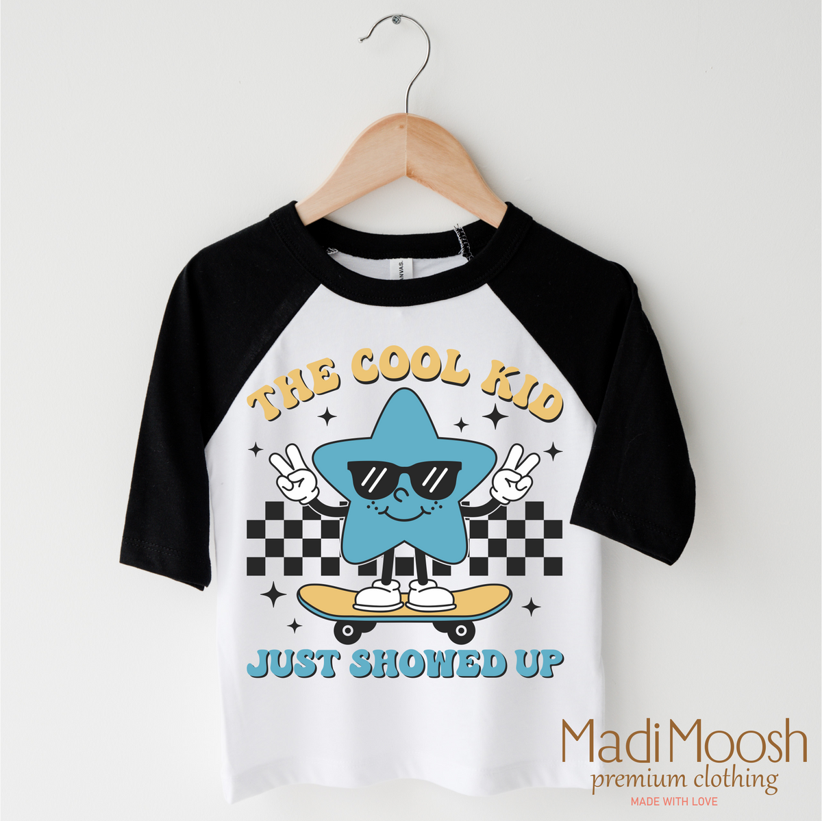 The Cool Kid Just Showed Up Back To School design on a black-accented shirt.