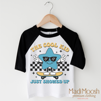 The Cool Kid Just Showed Up Back To School design on a black-accented shirt.
