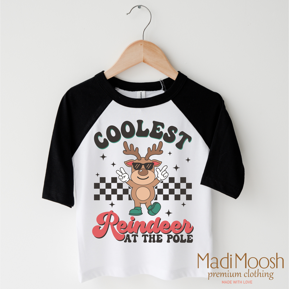 Coolest Reindeer At The Pole Christmas design on a black-accented shirt.