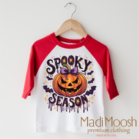 Spooky Season Pumpkin design on a red-accented shirt.