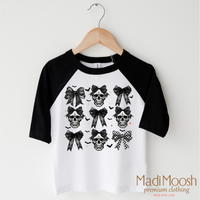 Skulls And Bows Halloween design on a raglan shirt with black sleeves.