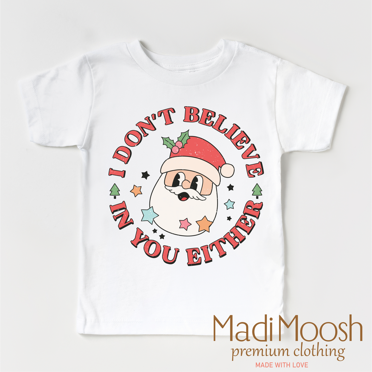 I Don't Believe In You Either Christmas design on a white garment.