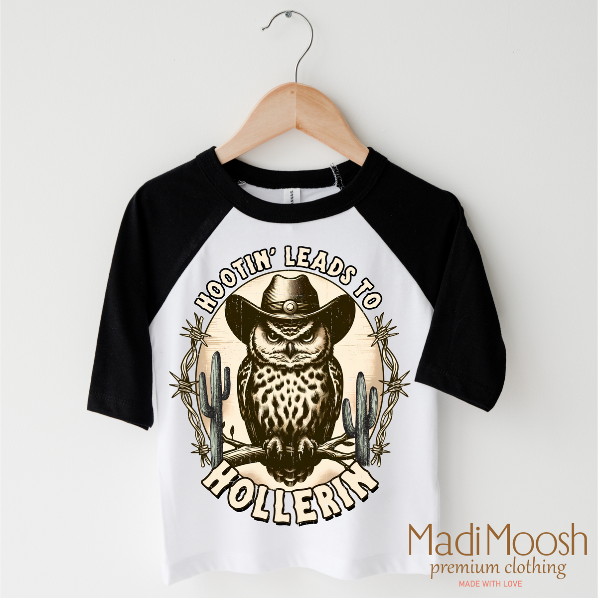 Hootin Leads To Hollerin Western design on a black-accented shirt.