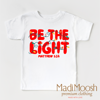 Be The Light Christmas design on a white garment.