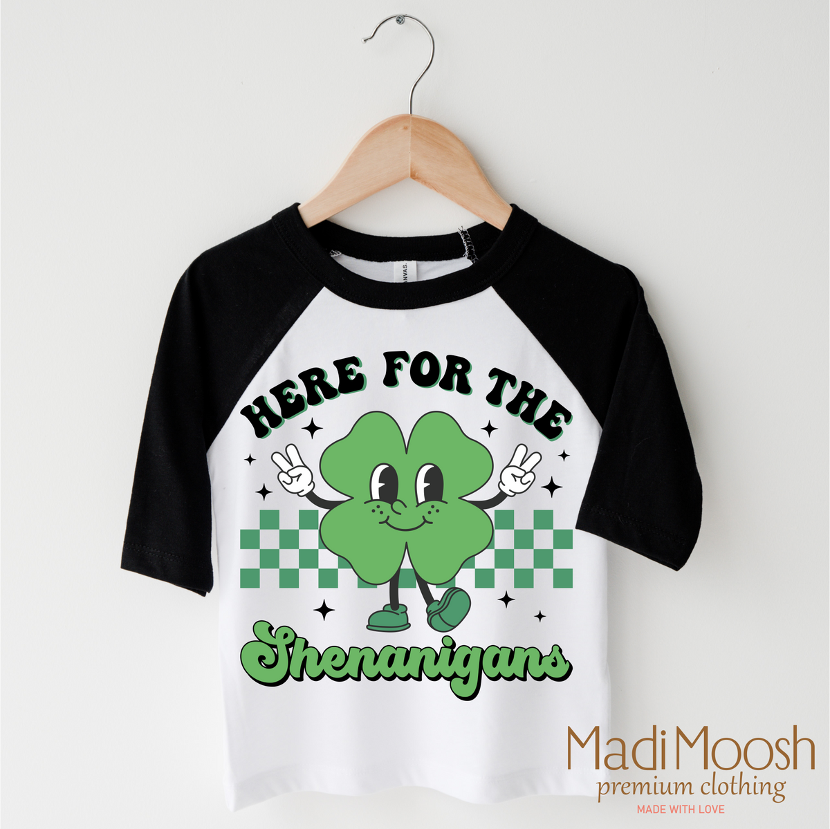 Here For The Shenanigan's St. Patrick's Day design on a black-accented shirt.