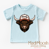 Howdy Highland Cow Western design on a blue garment.