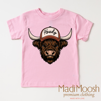 Howdy Highland Cow Western design on a pink garment.