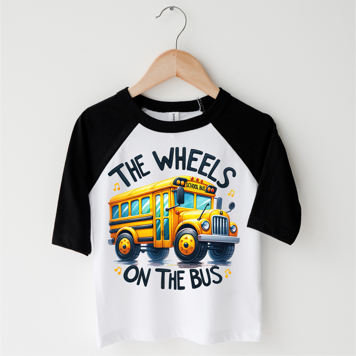 The Wheels On The Bus School design on a black-accented shirt.