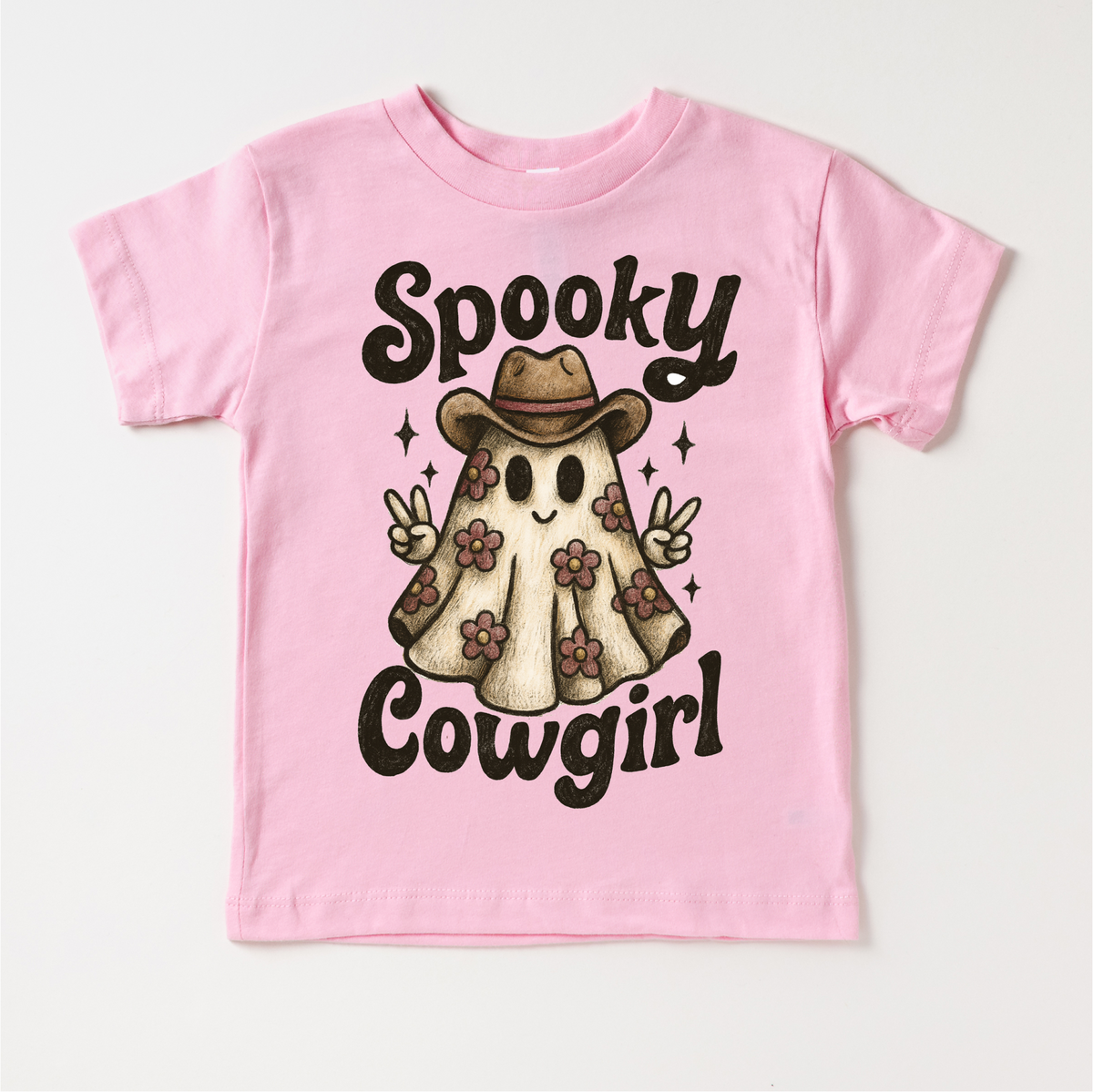 Spooky Cowgirl Halloween design on a pink garment.
