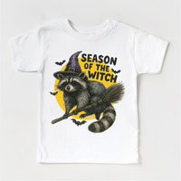 Season Of The Witch Raccoon Halloween design on a white garment.