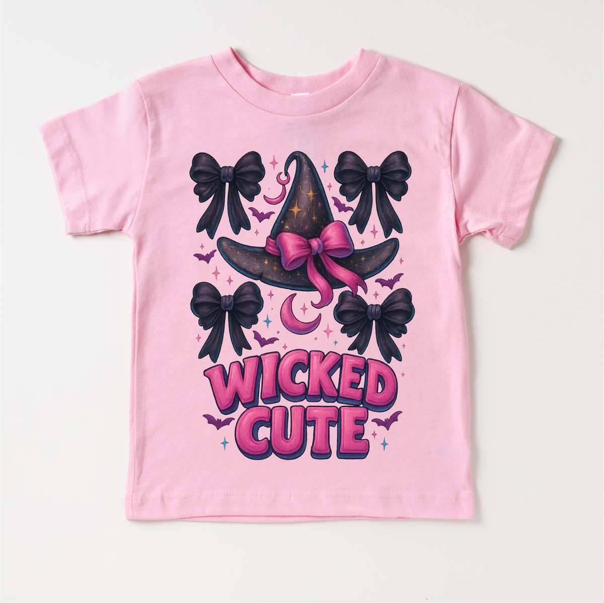 Wicked Cute Witch design on a pink garment.