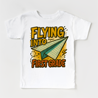 Flying Into First Grade Back To School design on a white garment.