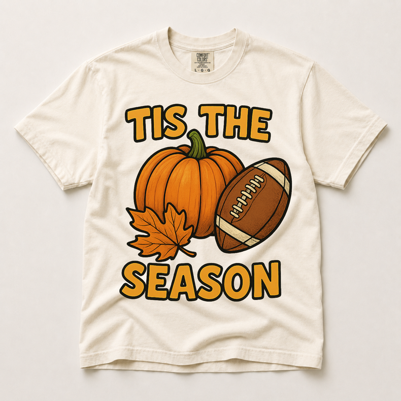 Tis the Season pumpkin and football graphic on an ivory Comfort Colors T-shirt