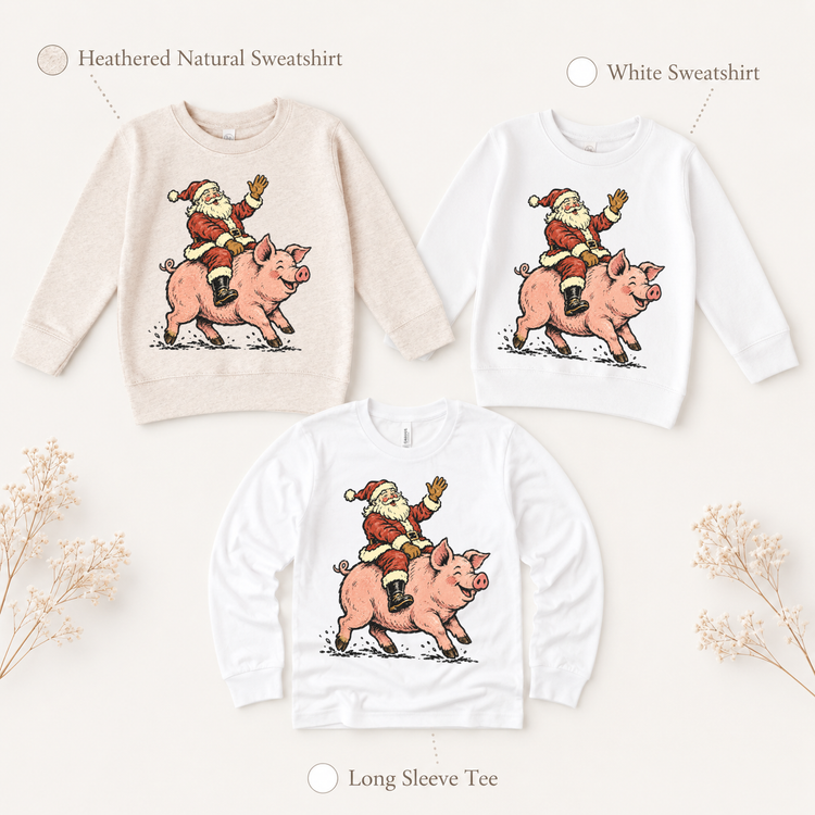 Santa riding a pink pig Christmas design on heathered natural and white sweatshirts and a white long-sleeve tee