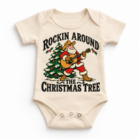 Rockin Around the Christmas Tree cowboy Santa guitar graphic on Natural Onesie