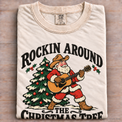 Natural Comfort Colors Rockin Around the Christmas Tree Shirt folded on wood