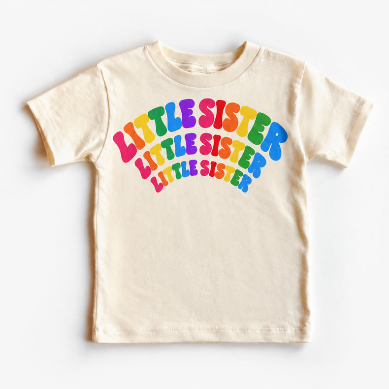 Little Sister rainbow arched lettering on natural tee