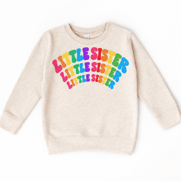 Little Sister rainbow arched lettering on natural heather sweatshirt