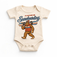 I'd Rather Be Snowboarding retro Bigfoot design on a natural baby bodysuit