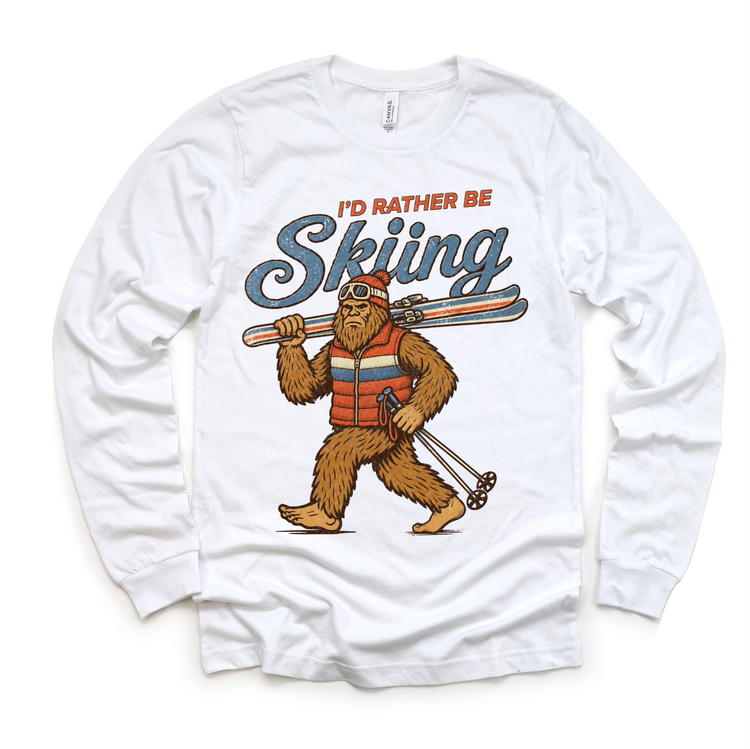 I'd Rather Be Skiing retro Bigfoot carrying skis design on a white long sleeve tee