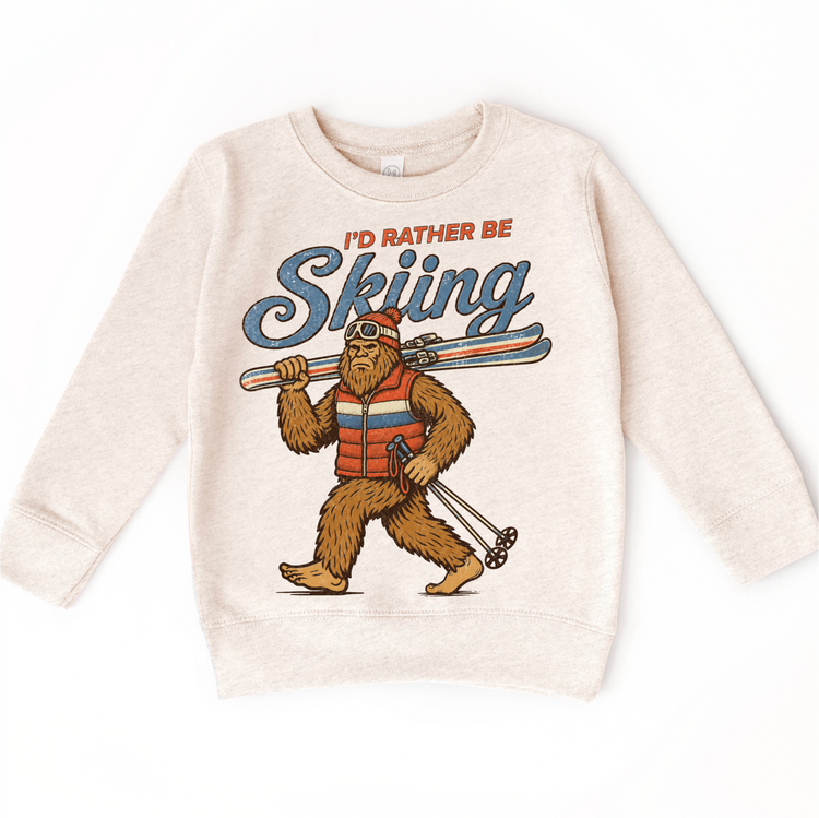 I'd Rather Be Skiing retro Bigfoot carrying skis design on a natural heather sweatshirt