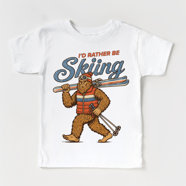 I'd Rather Be Skiing retro Bigfoot carrying skis design on a white short sleeve tee