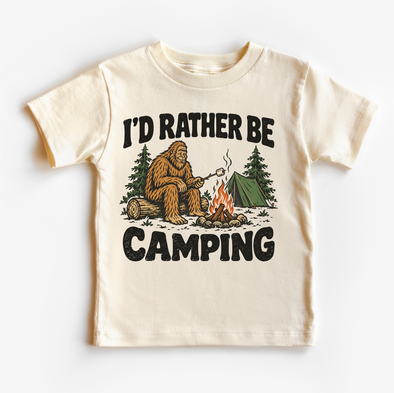 I'd Rather Be Camping Bigfoot roasting a marshmallow by a campfire on a natural short sleeve tee