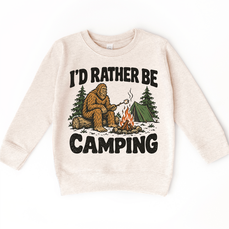 I'd Rather Be Camping Bigfoot roasting a marshmallow by a campfire on a natural heather sweatshirt